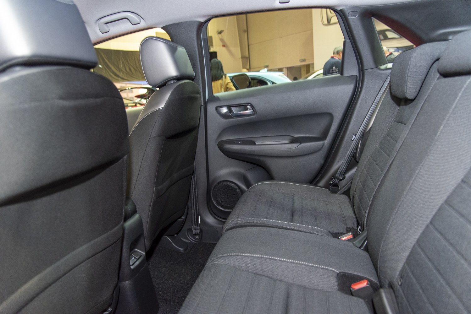 Rear seating area with fabric-covered seats and rear door panel