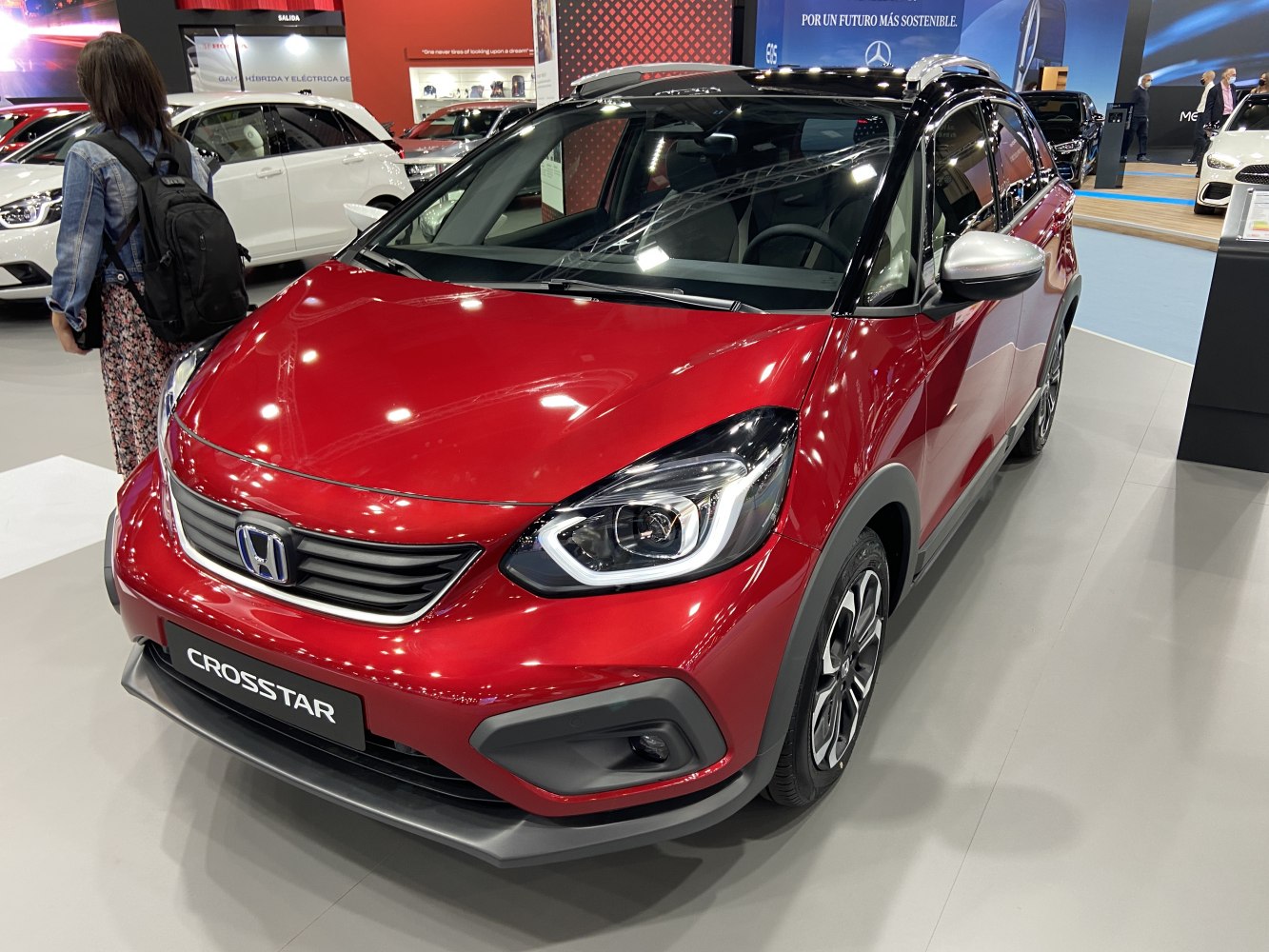 Red Crosstar compact SUV with LED headlights and black roof.