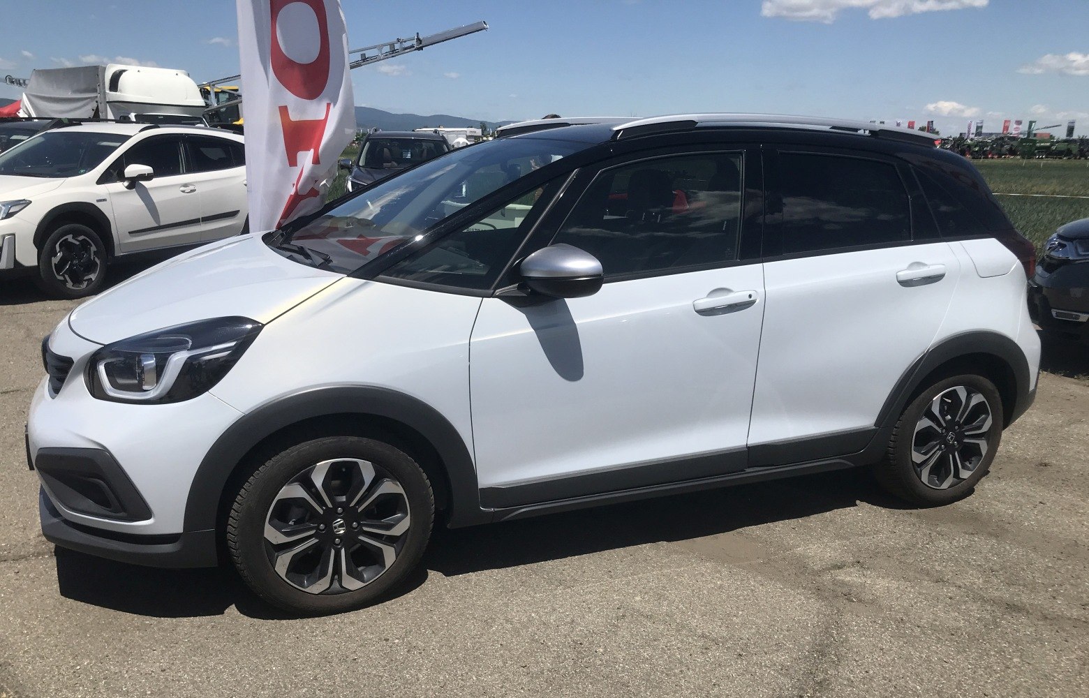 White compact hatchback with black roof and alloy wheels