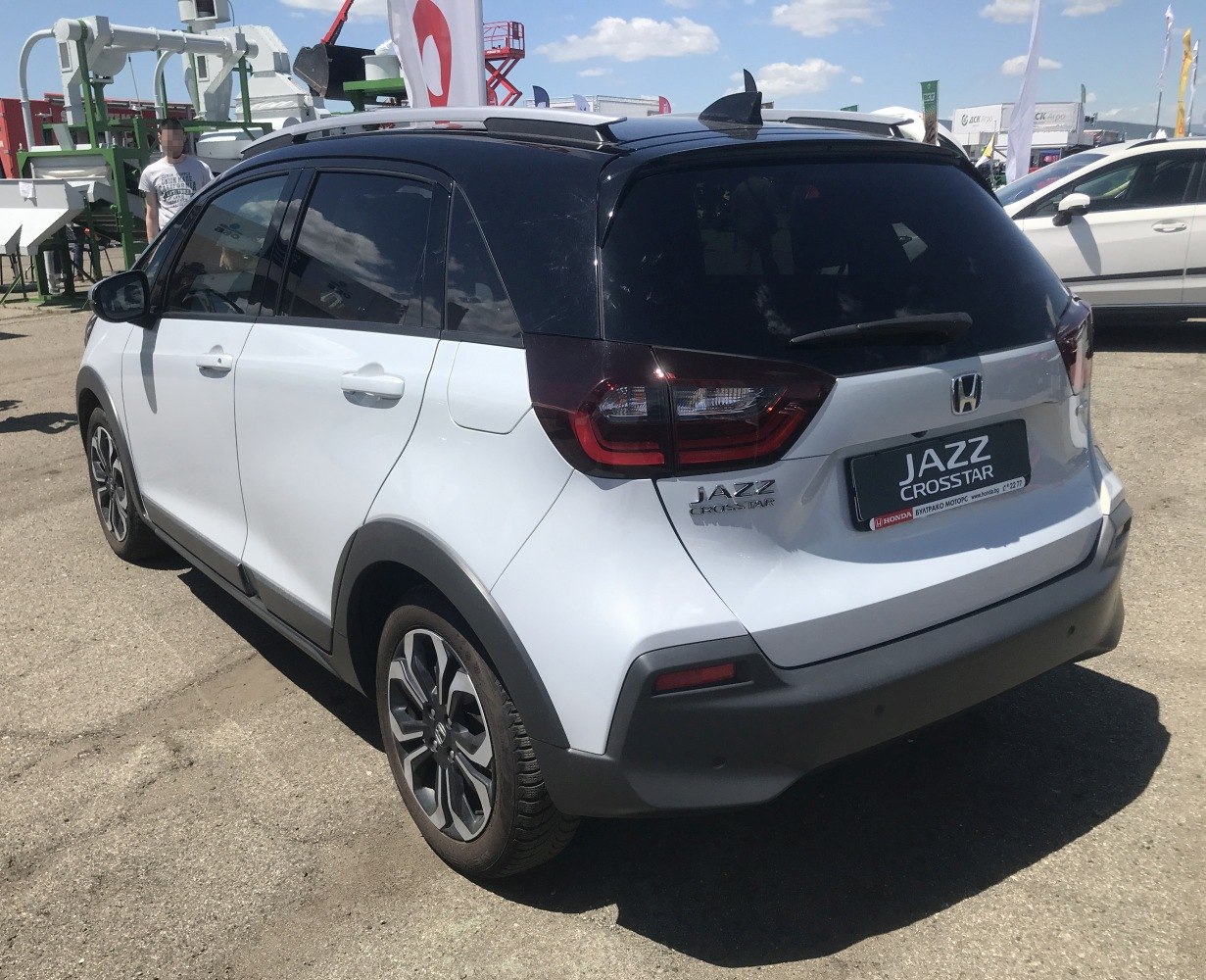 Rear side view of white two-tone compact crossover with distinctive taillights