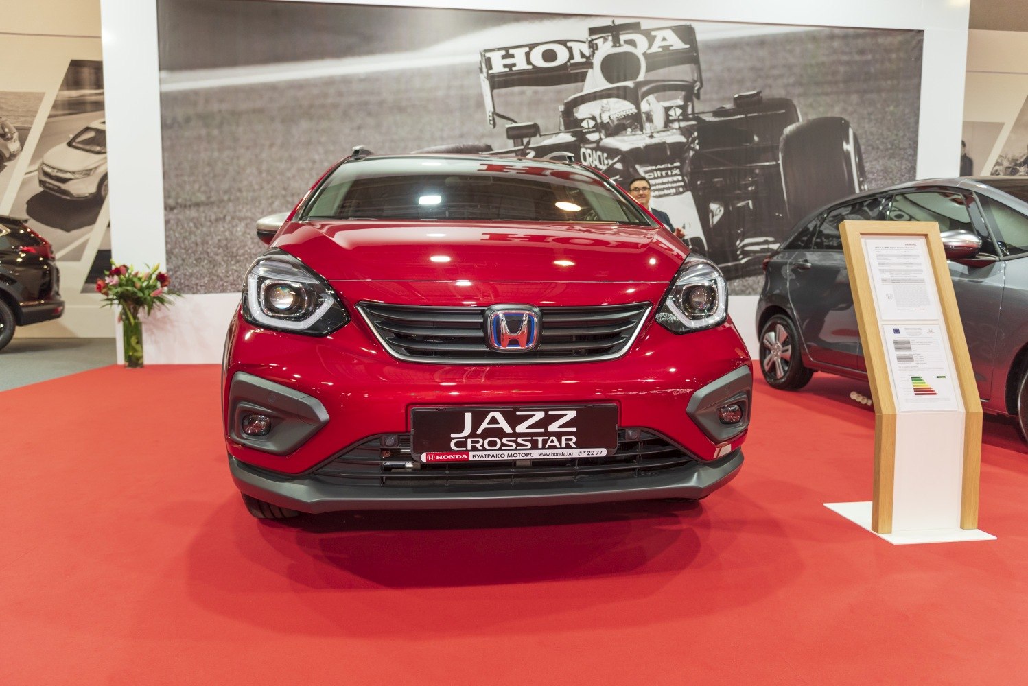 Front view of red car with distinct grille and headlights