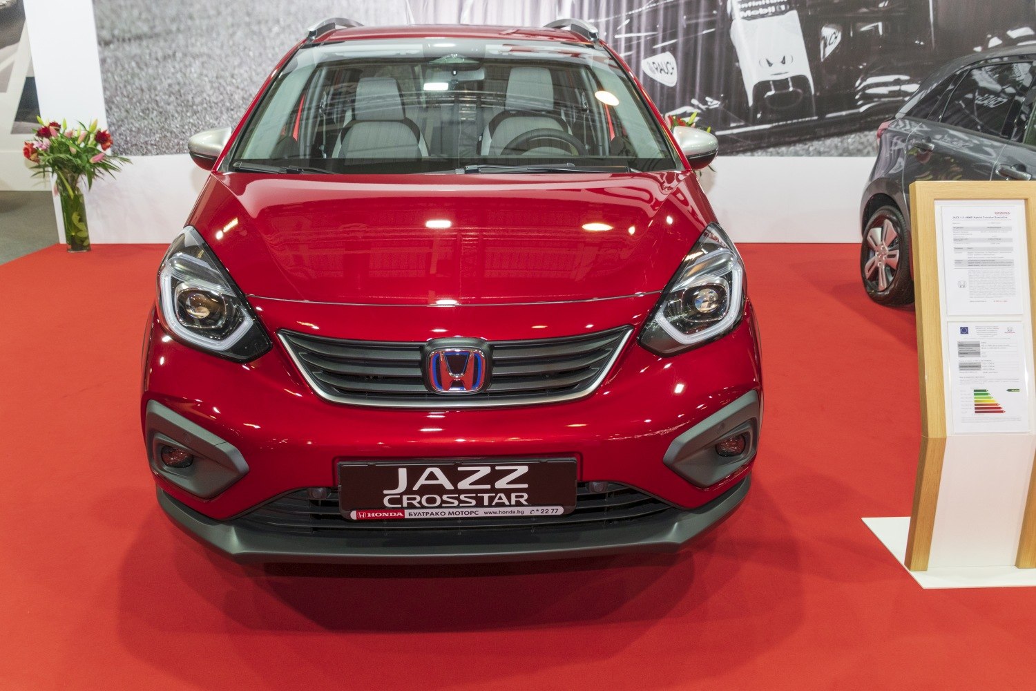 Red compact crossover front with distinct headlights and grille