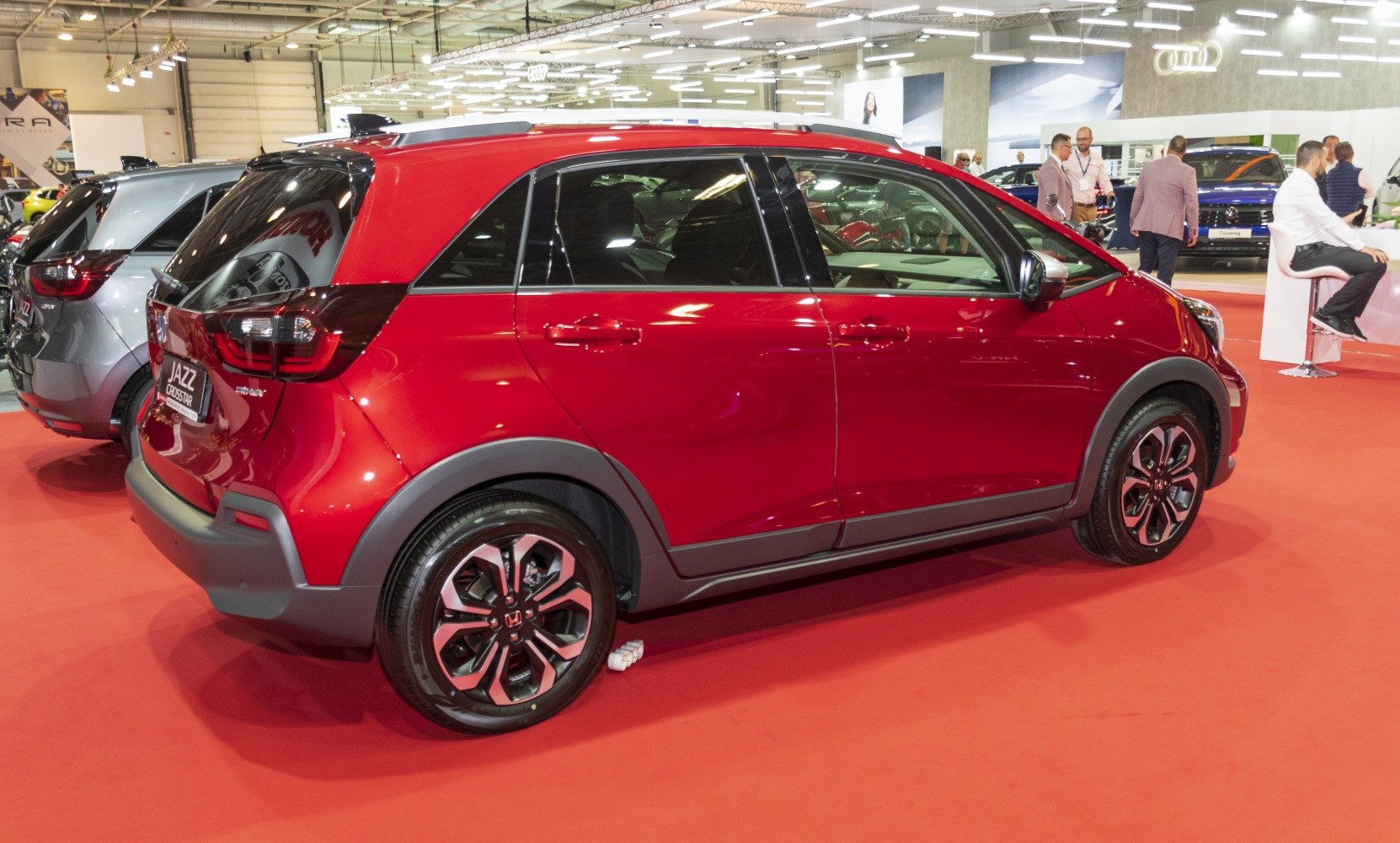 Red compact hatchback with two-tone roof and alloy wheels