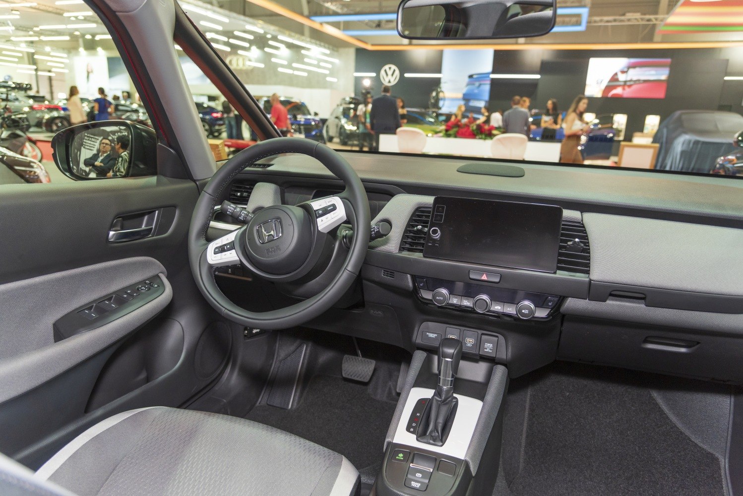 Modern car dashboard with touchscreen and multifunction steering wheel