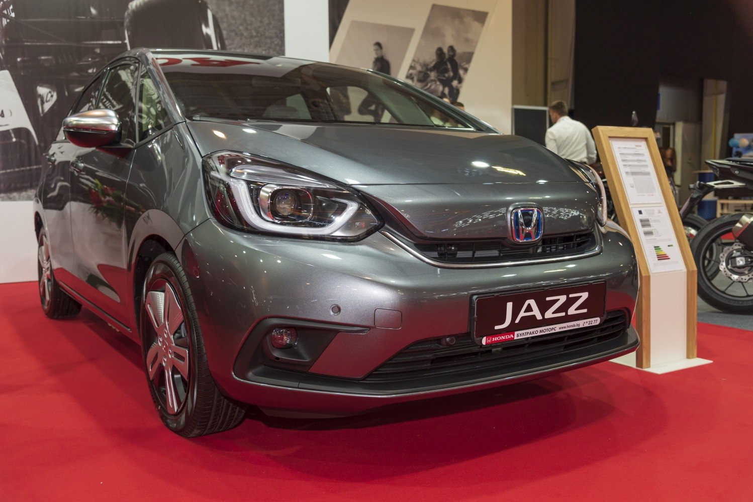 Front close-up of hatchback with prominent LED headlights and sleek aerodynamic design
