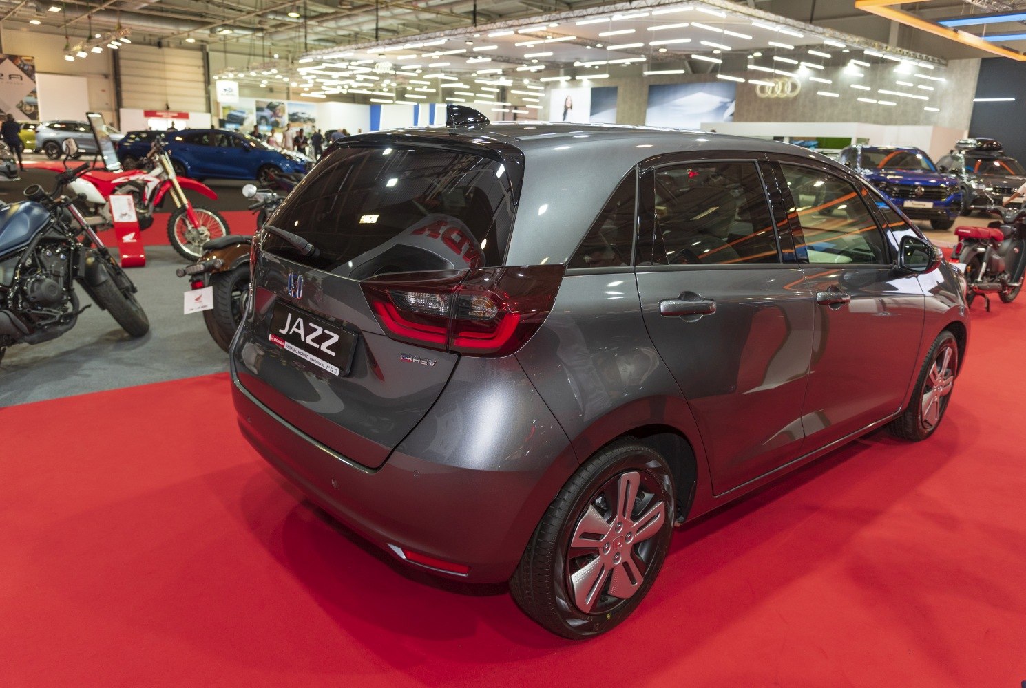 Rear and side view of a hybrid hatchback with modern taillights and alloy wheels