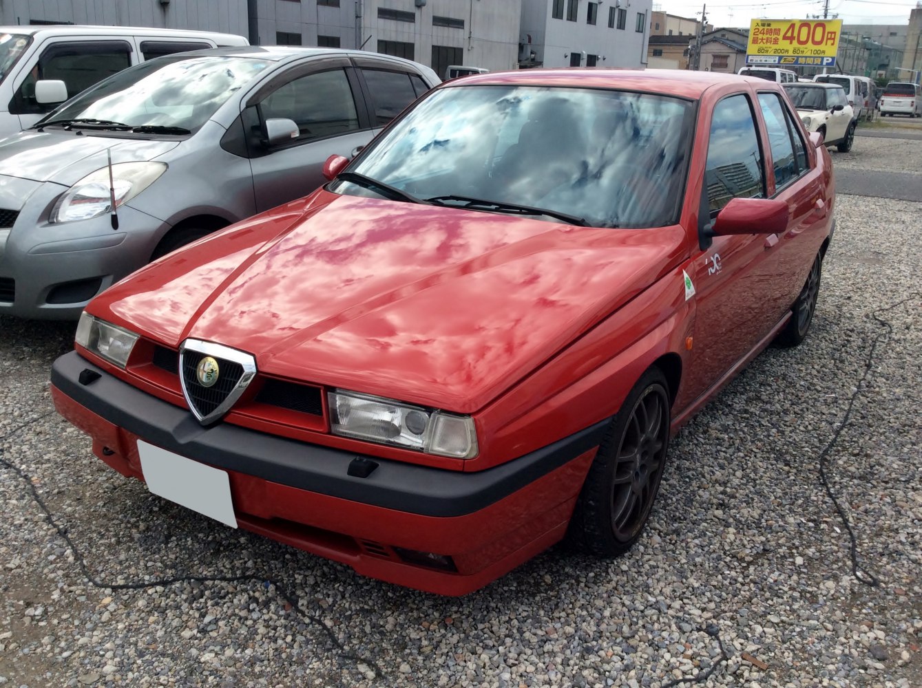 Red sedan with angular headlights and sporty front-end design