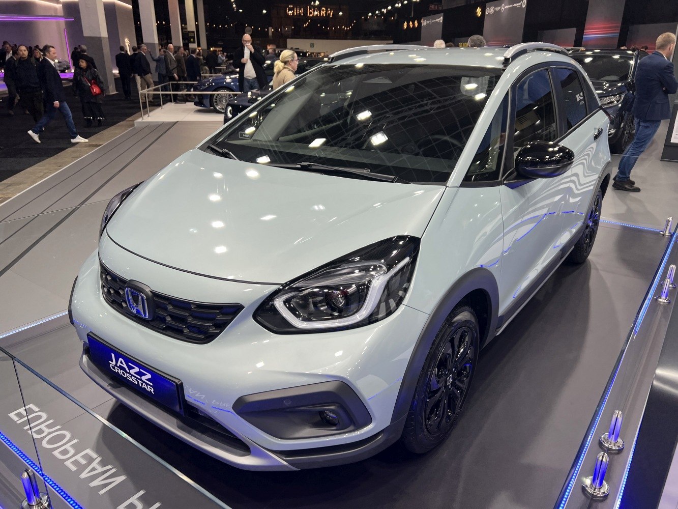 Front and side view showing distinctive grille and headlights with black accents