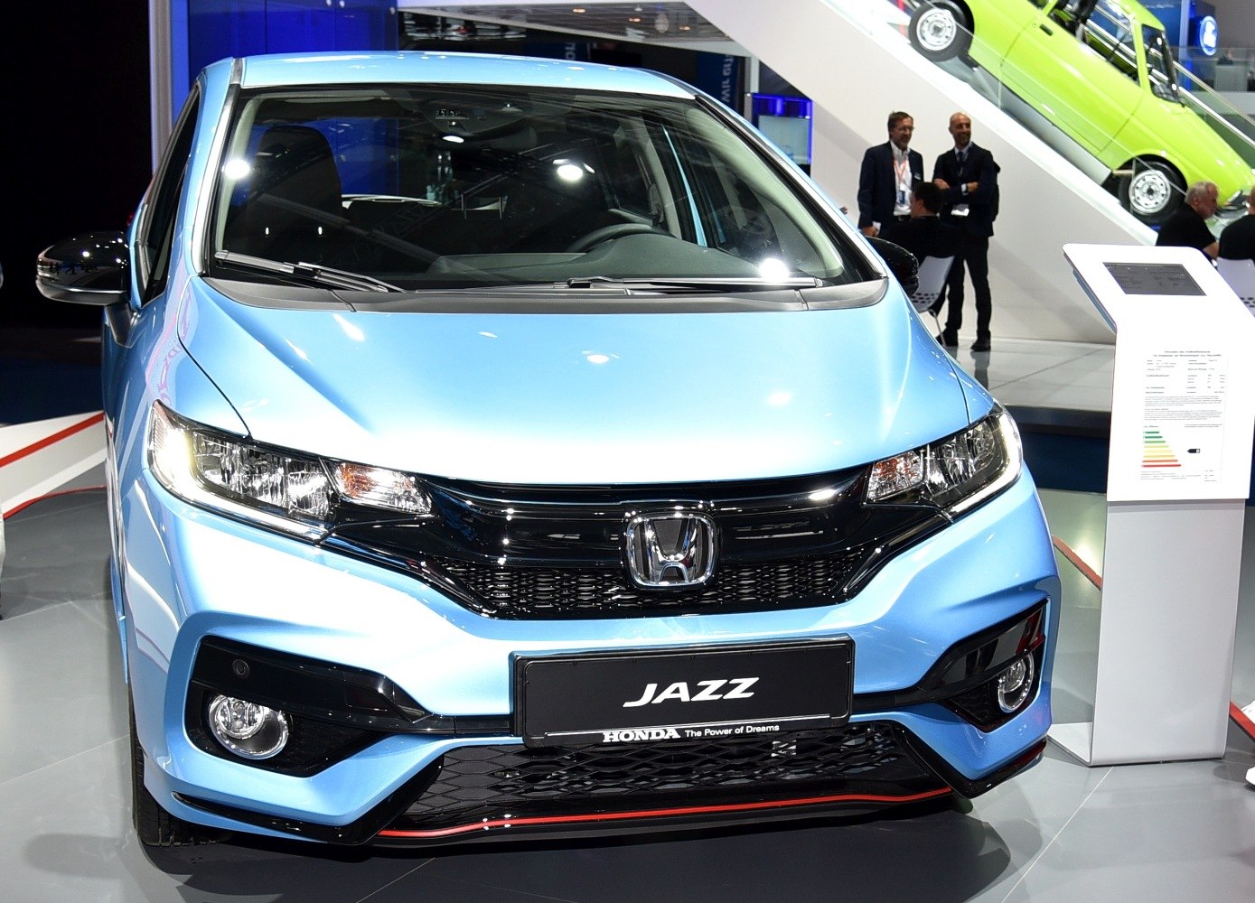 Compact hatchback with sleek headlights and black grille front view