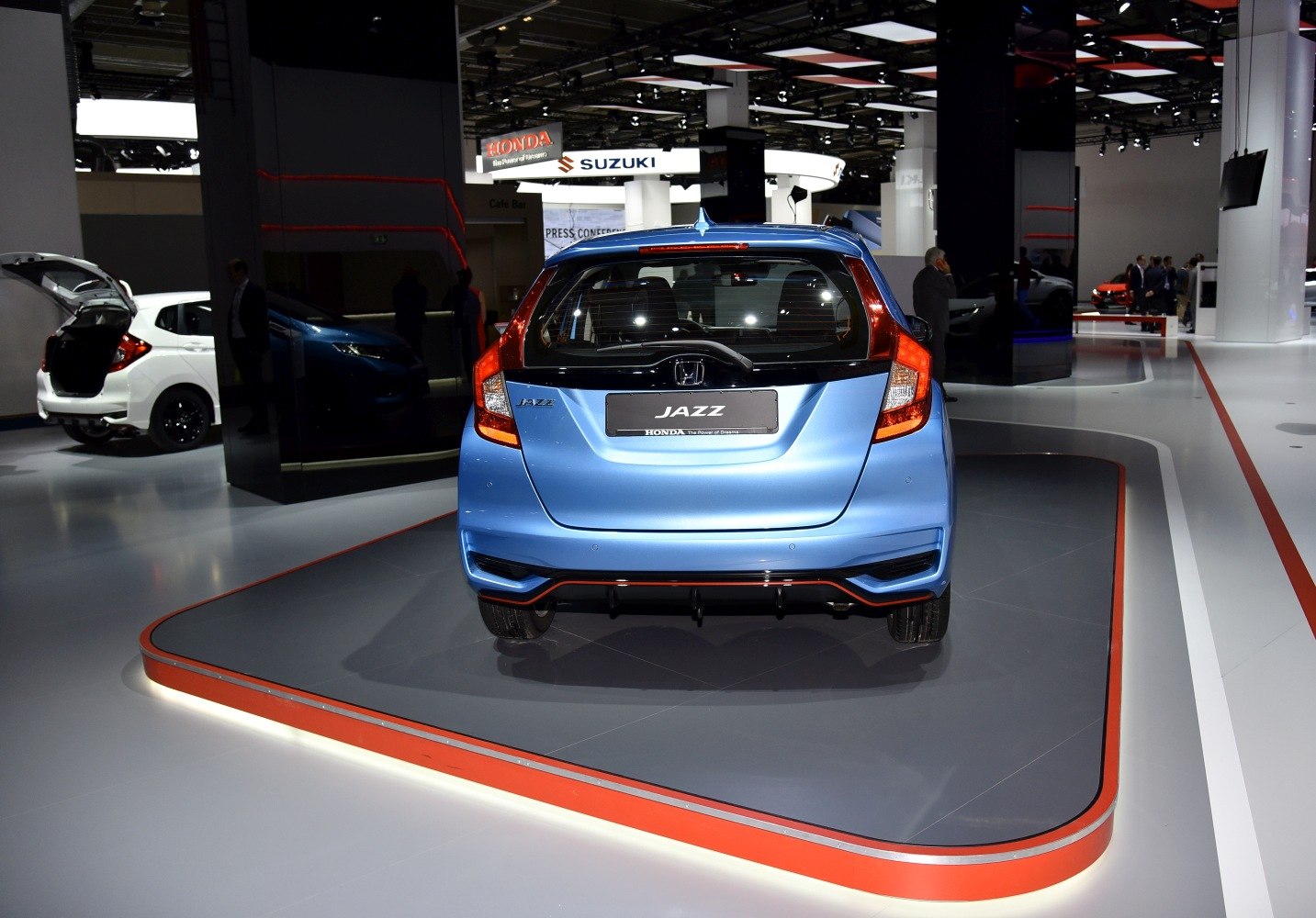 Rear view of a blue hatchback with distinctive vertical taillights.