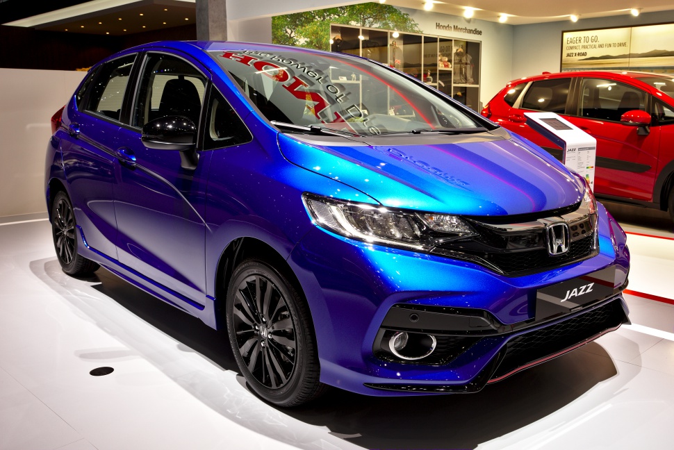 Sporty front of compact hatchback with LED headlights and black wheels
