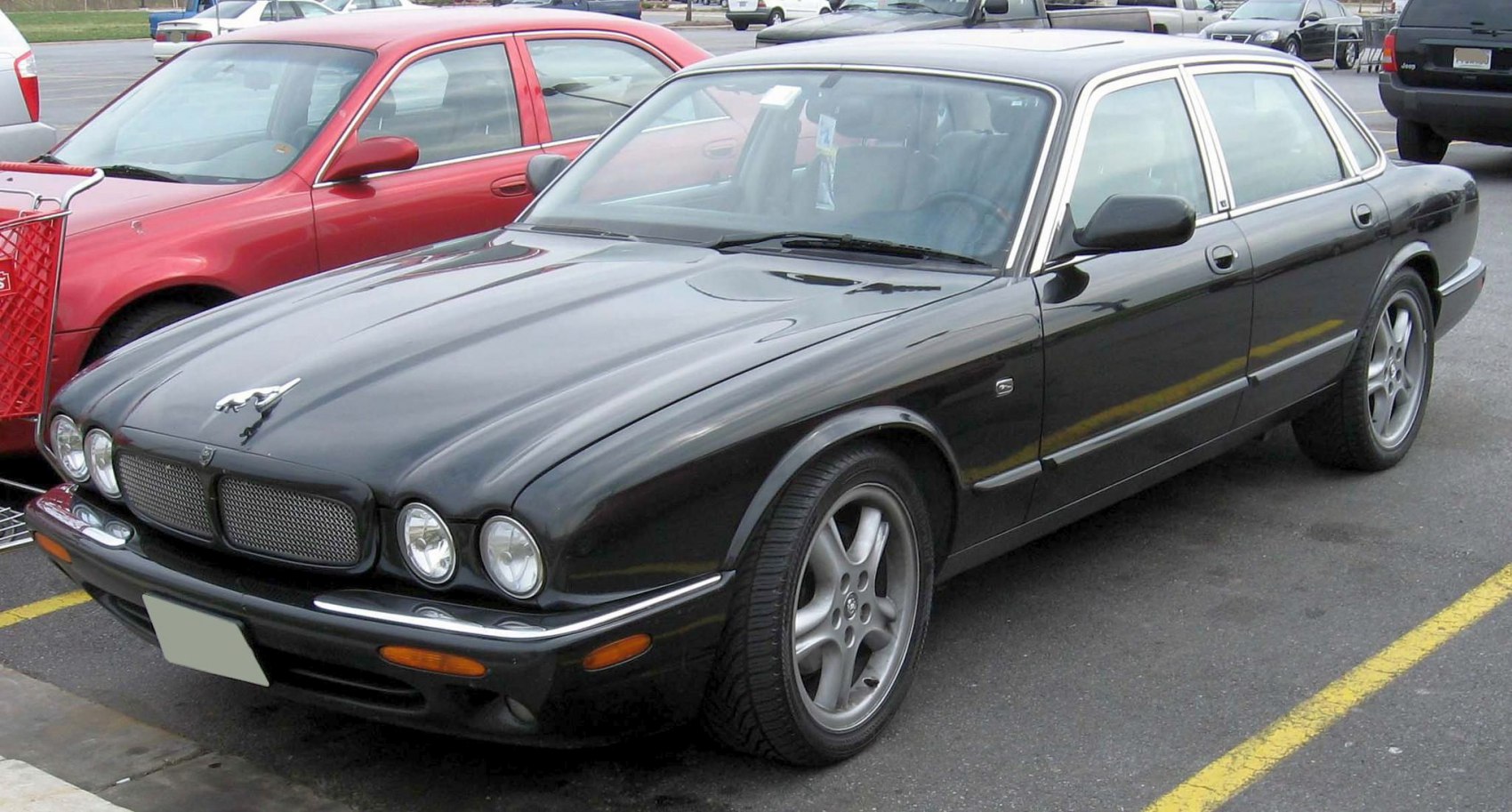 Luxury sedan with dual round headlights and mesh grille in classic design
