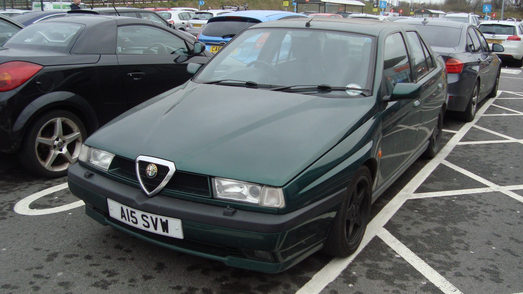Front view of a 1990s hatchback with classic headlights and grille
