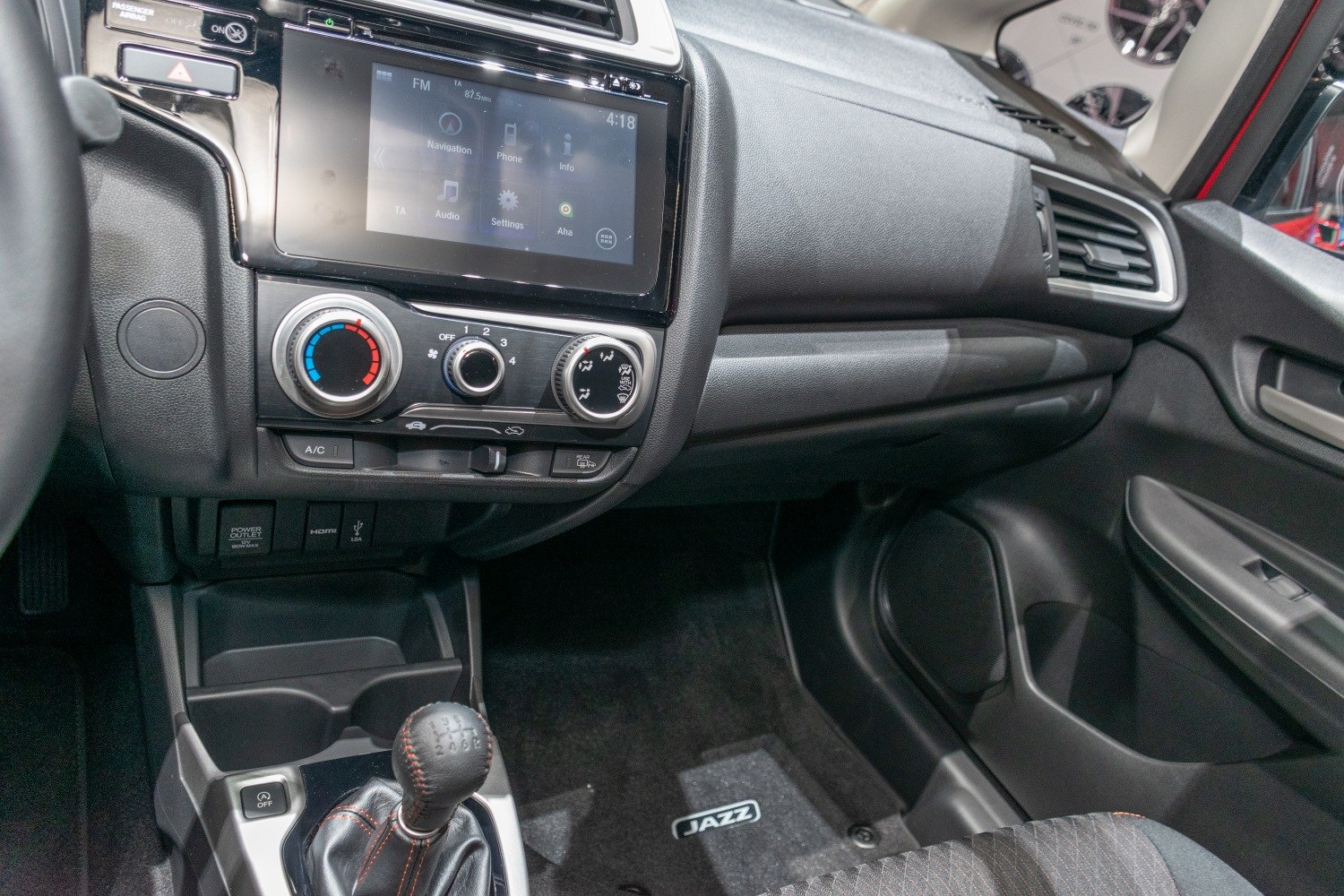 Dashboard controls and manual gearshift with touchscreen infotainment
