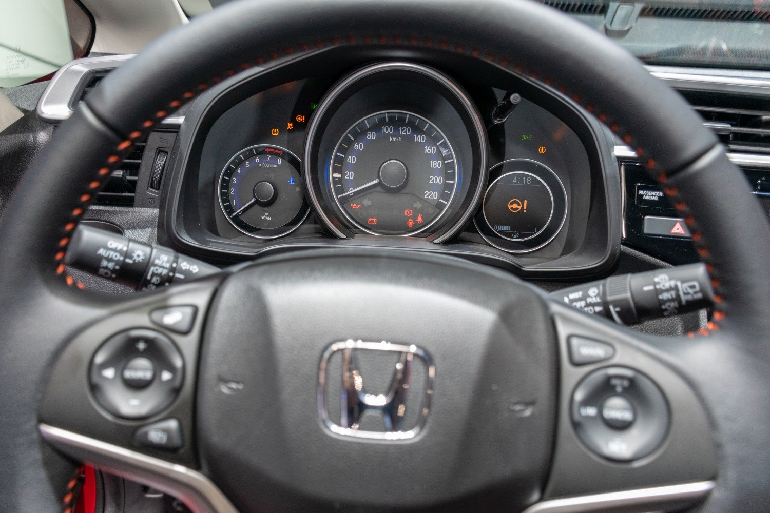 Instrument cluster with analog speedometer and tachometer plus steering wheel controls