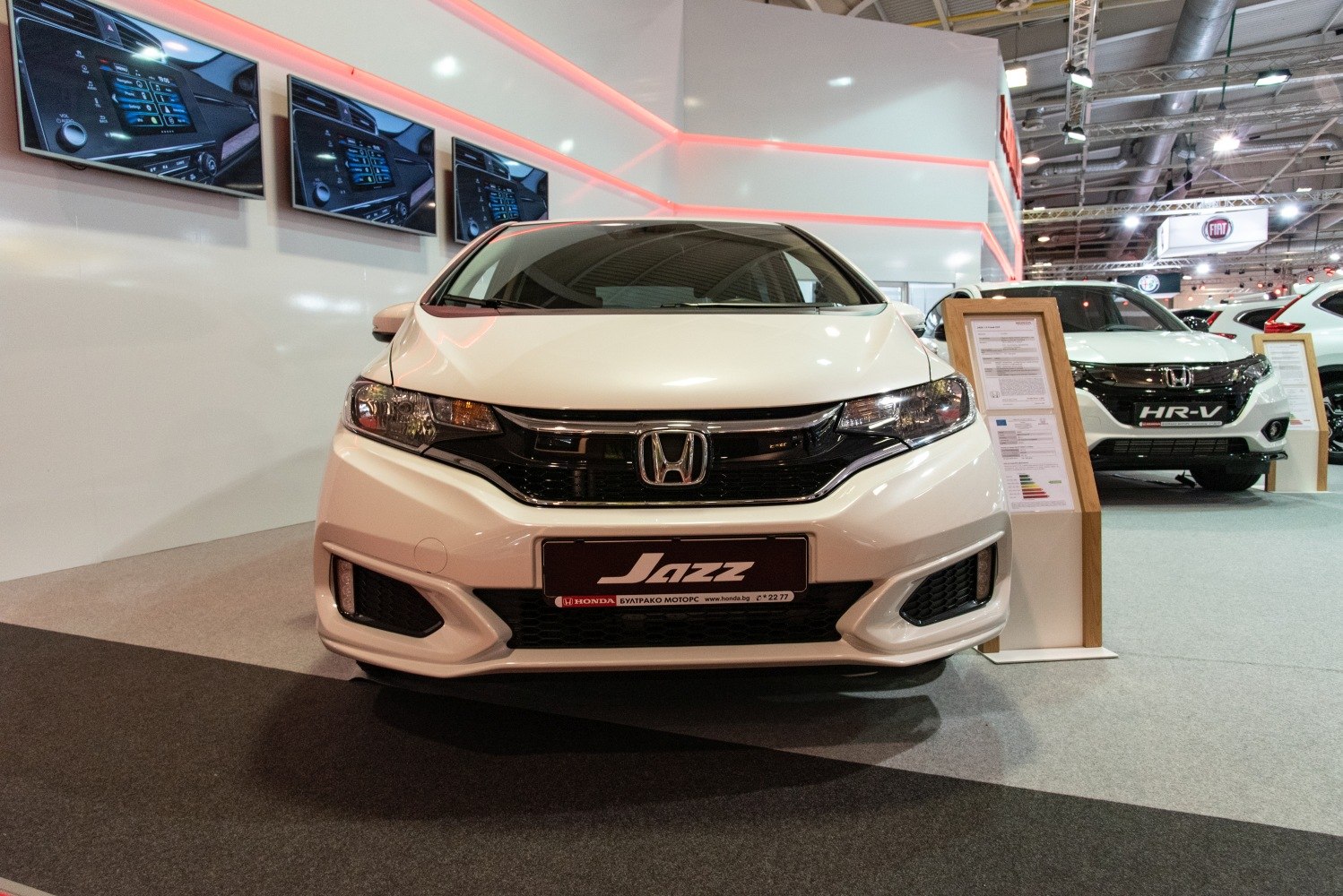 Modern compact car front with LED headlights and bold black grille