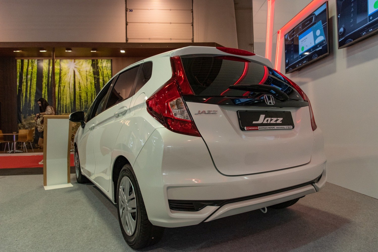 Rear view of compact hatchback with distinct taillights and rear window spoiler