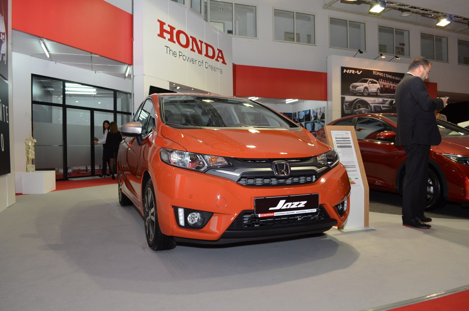 Orange compact hatchback front with sleek headlights