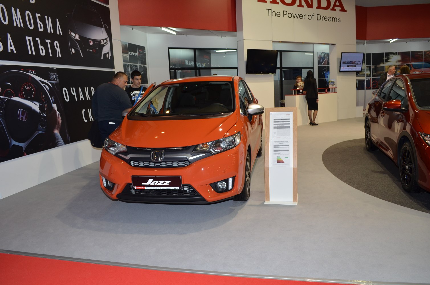 Compact hatchback front view with distinctive grille and LED headlights