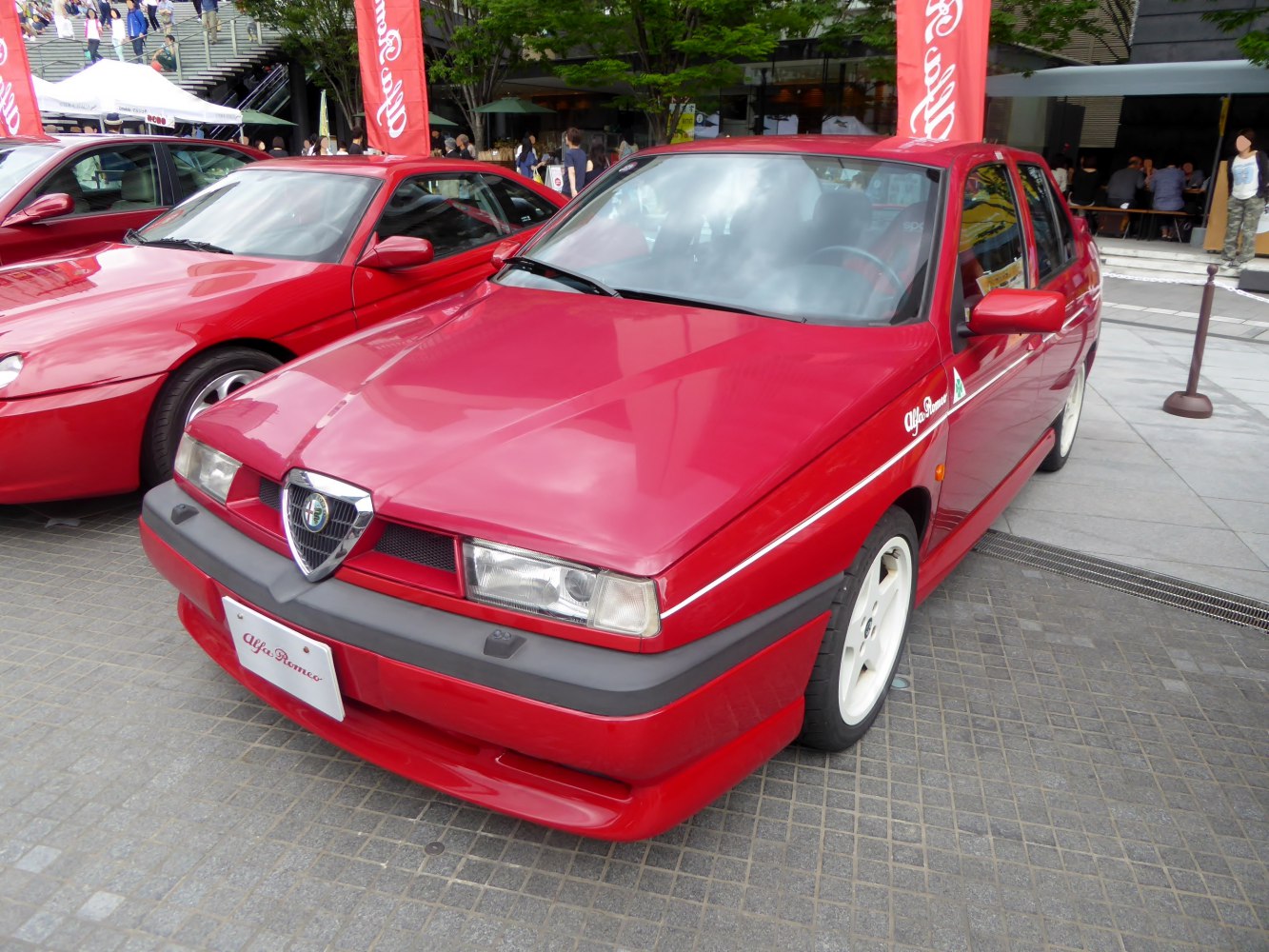 Red sedan with angular headlights and white wheels