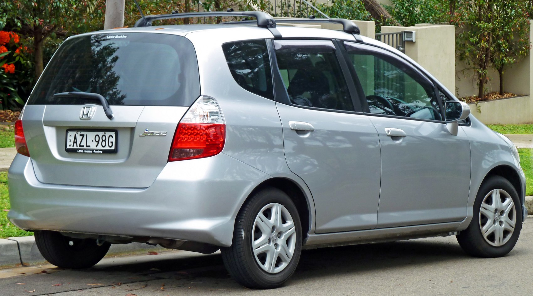Rear side view with roof rails of a silver hatchback car