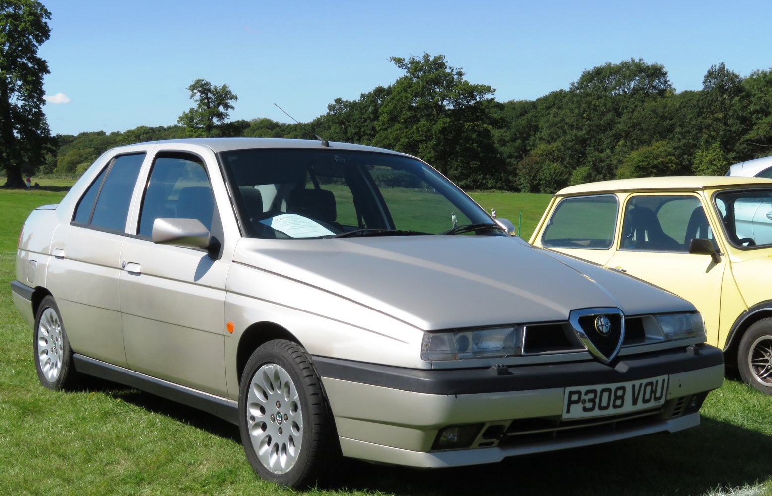 Front 3/4 view of classic four-door sedan with angular headlights and alloy wheels