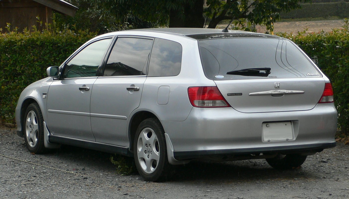 Silver station wagon rear side with tinted windows and five-spoke wheels