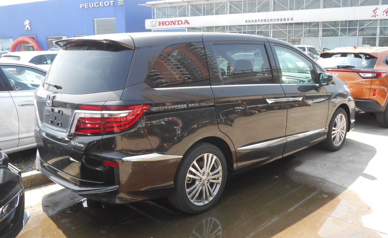 Rear view of a luxury MPV with chrome trim and modern tail lights