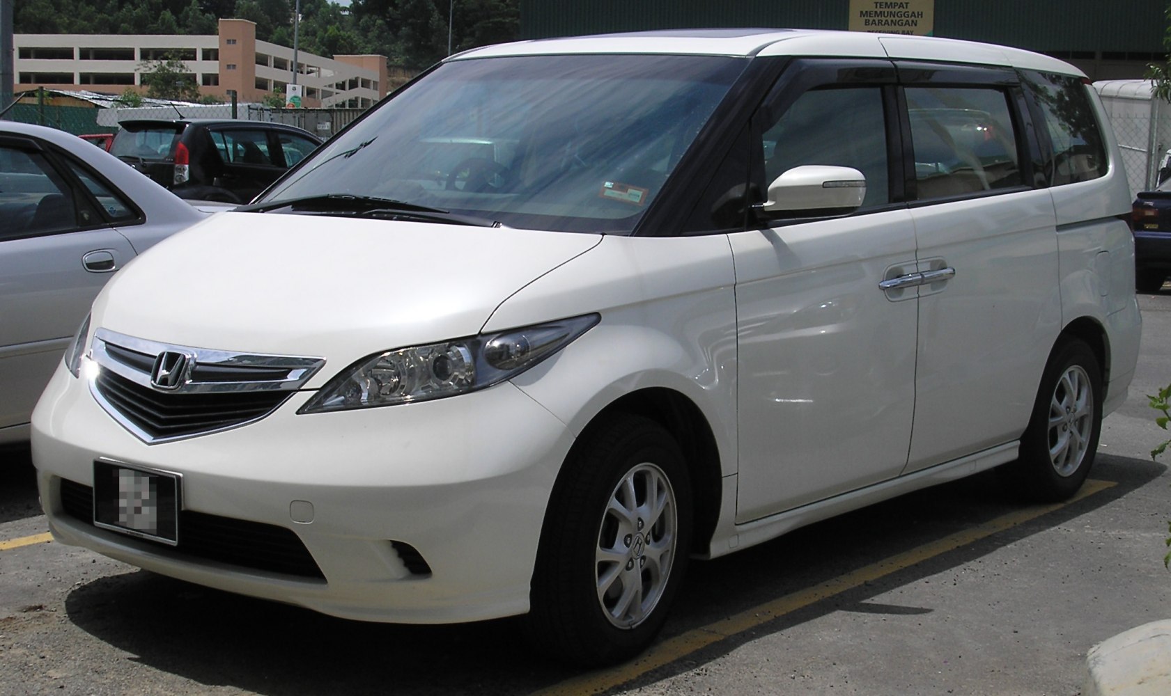 White minivan with sleek headlights and chrome grille
