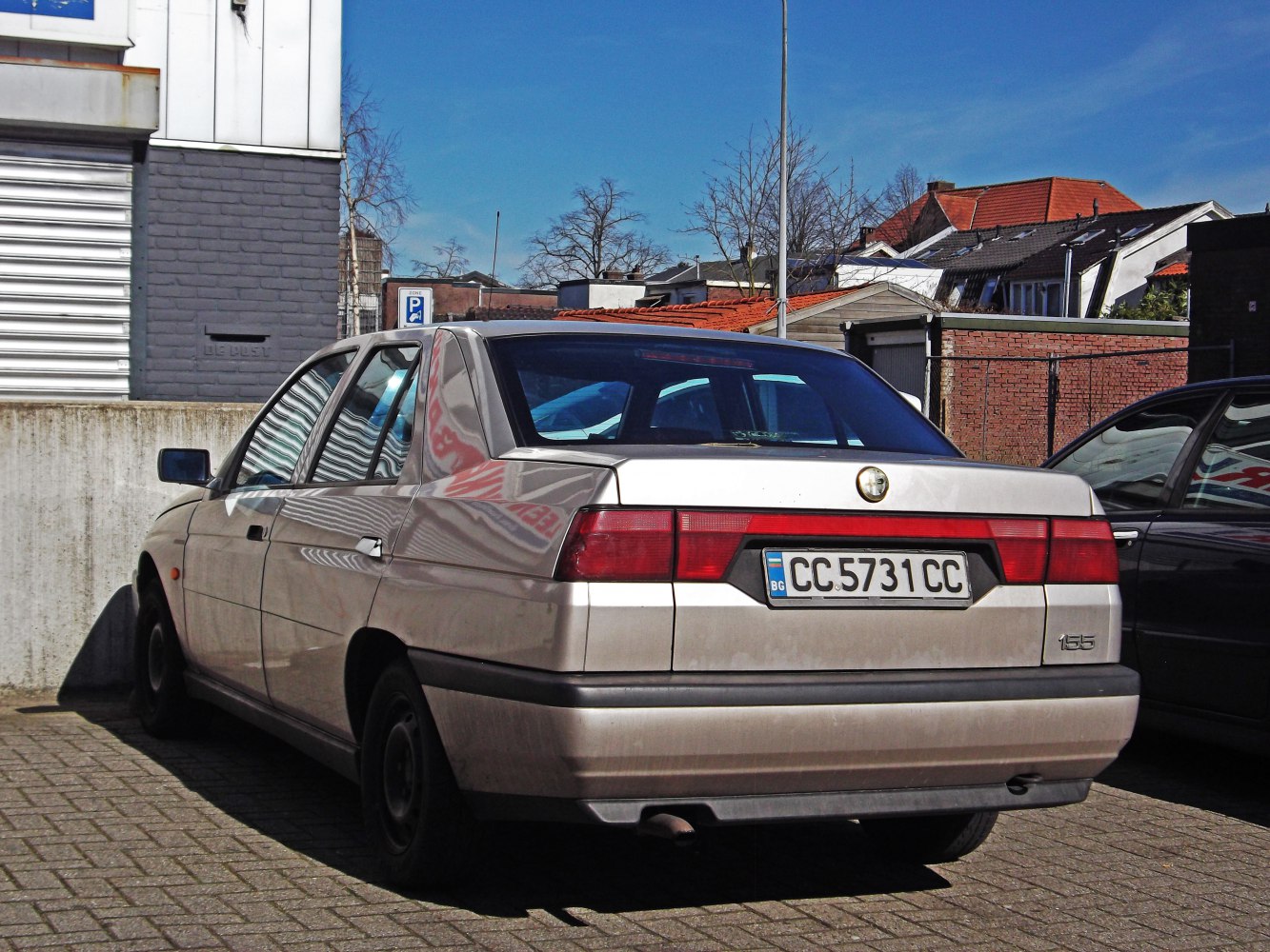 Rear view of sedan with wide rectangular tail lights and angular body lines