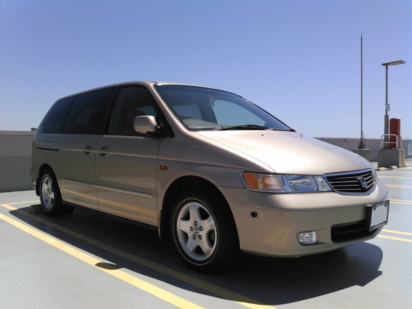 Minivan front side view with sliding door and alloy wheels