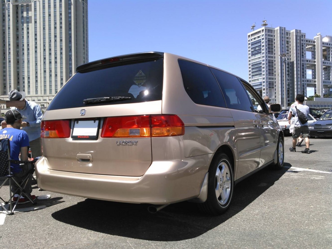 Rear and side view of a minivan with tinted windows and taillights