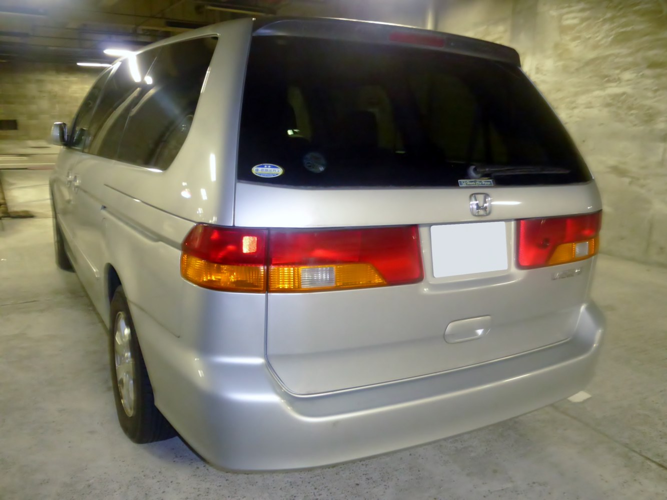 Rear view with tail lights, rear windshield, and bumper