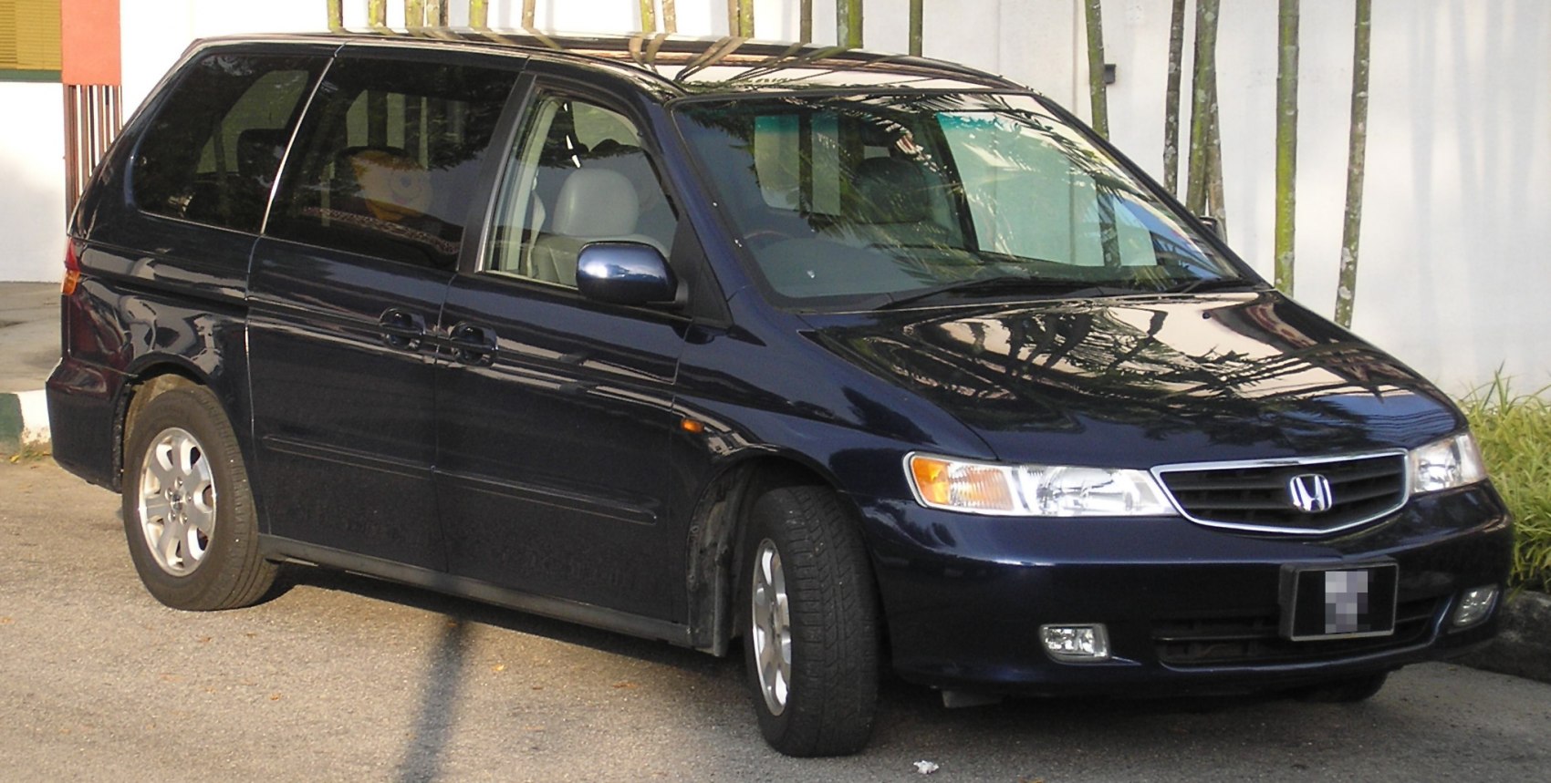 Minivan front three-quarter view with sliding side doors and alloy wheels