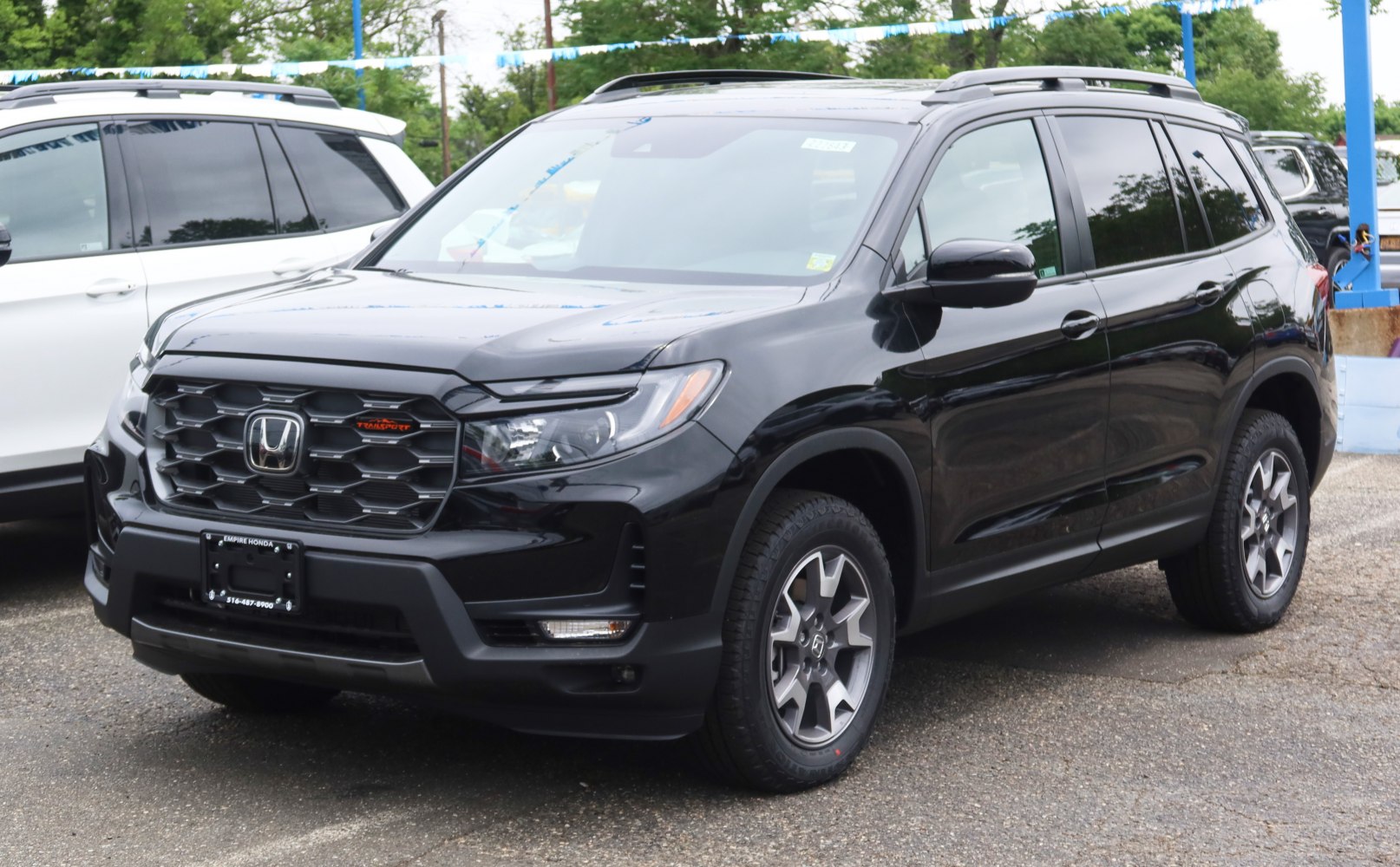 Black mid-size SUV with rugged front grille and alloy wheels