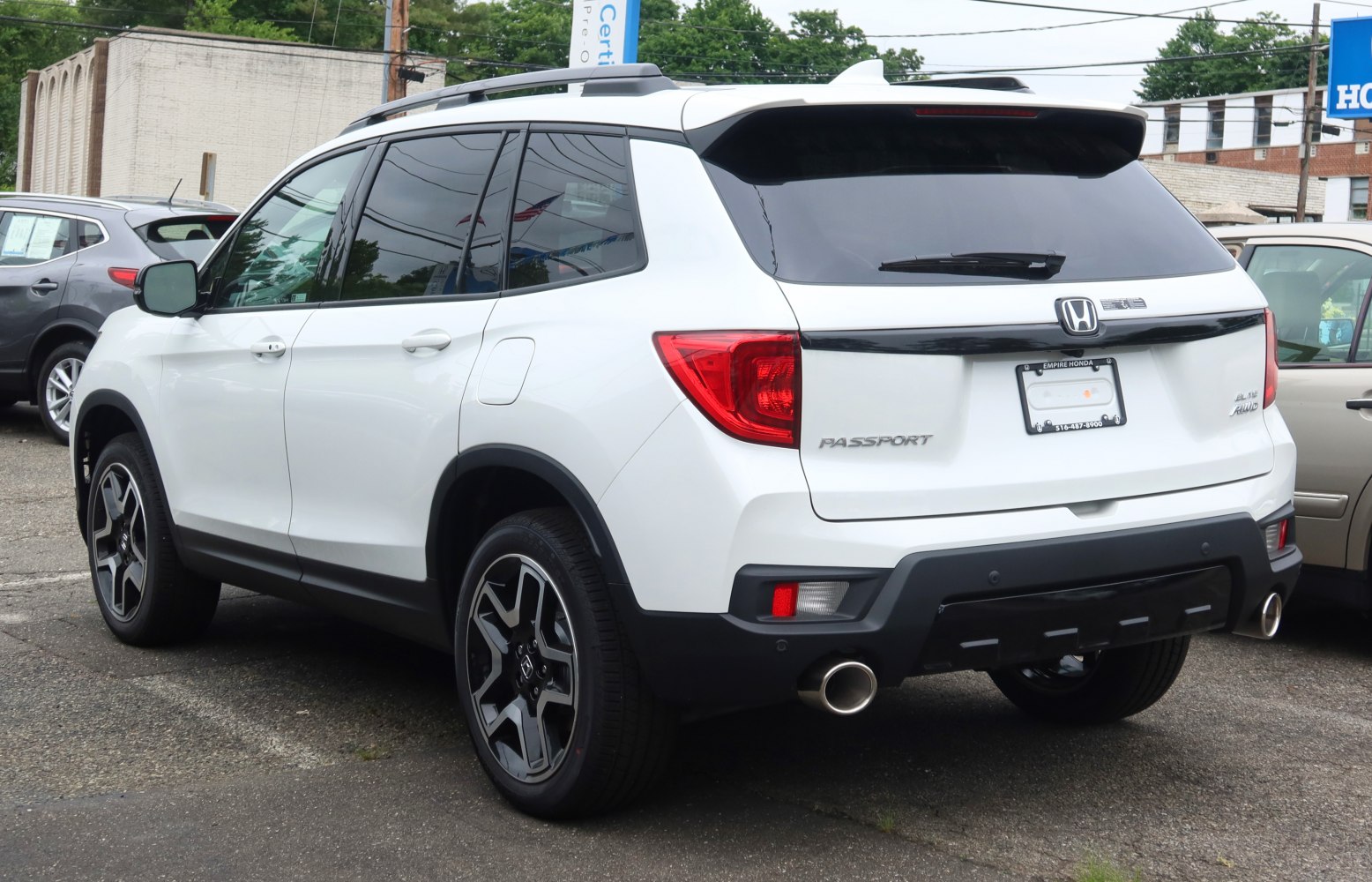 Rear view with dual exhausts and alloy wheels on a midsize SUV