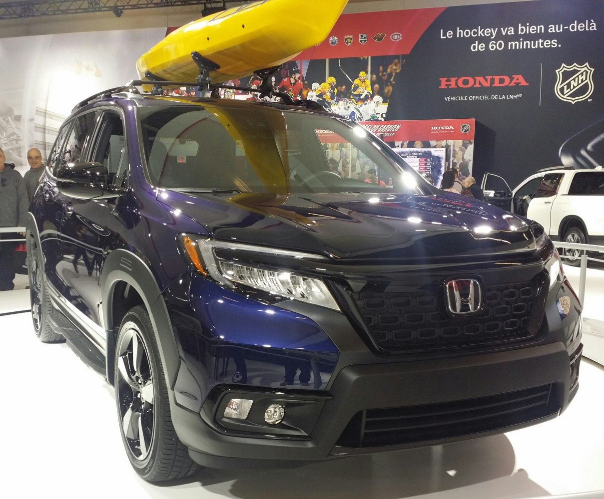 Modern SUV with roof rack and yellow kayak on top