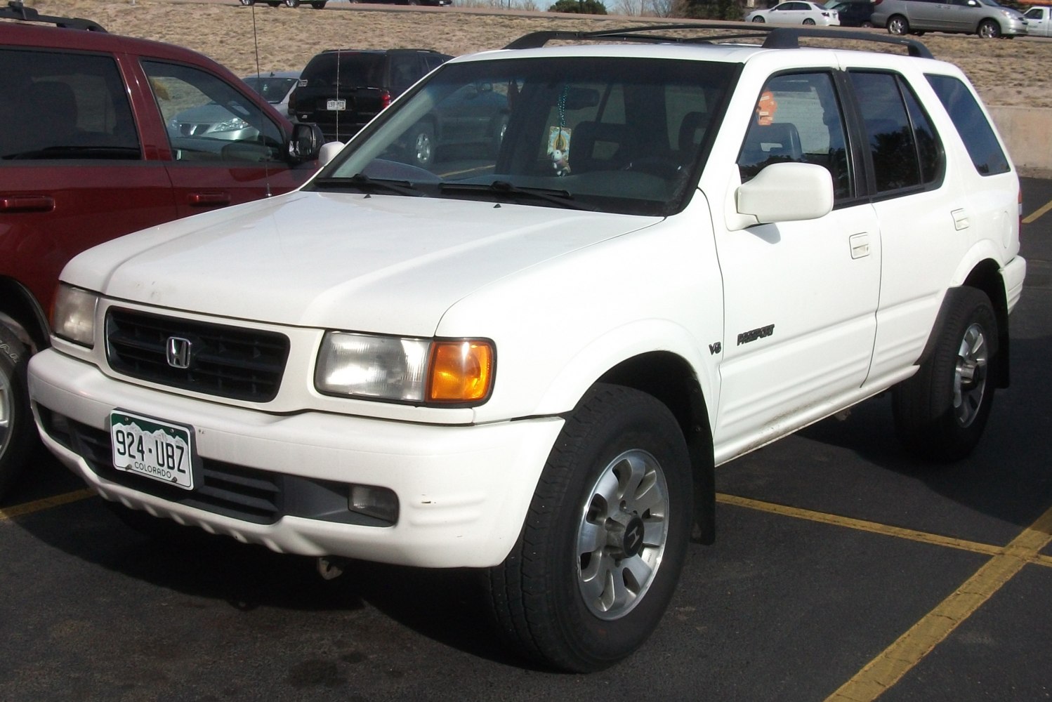 White SUV with V6 badge and rectangular headlights