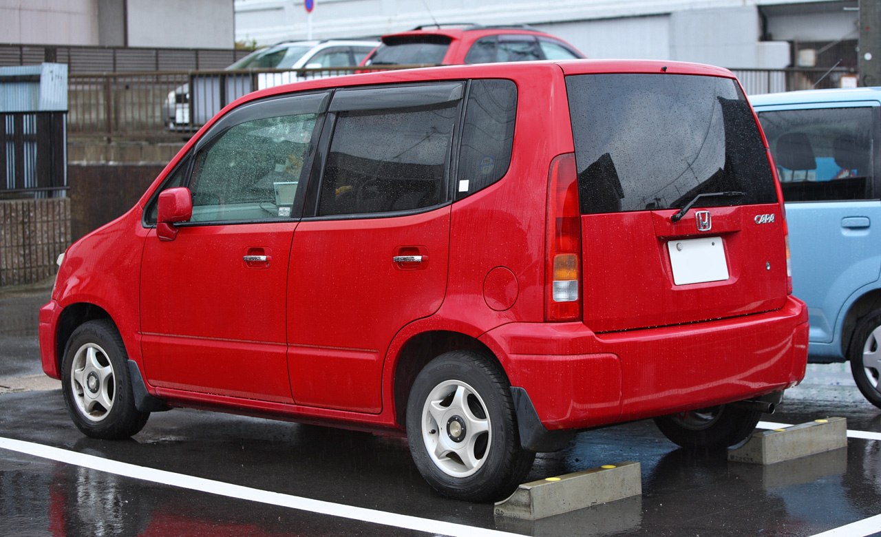 Red compact hatchback with boxy rear side and taillights
