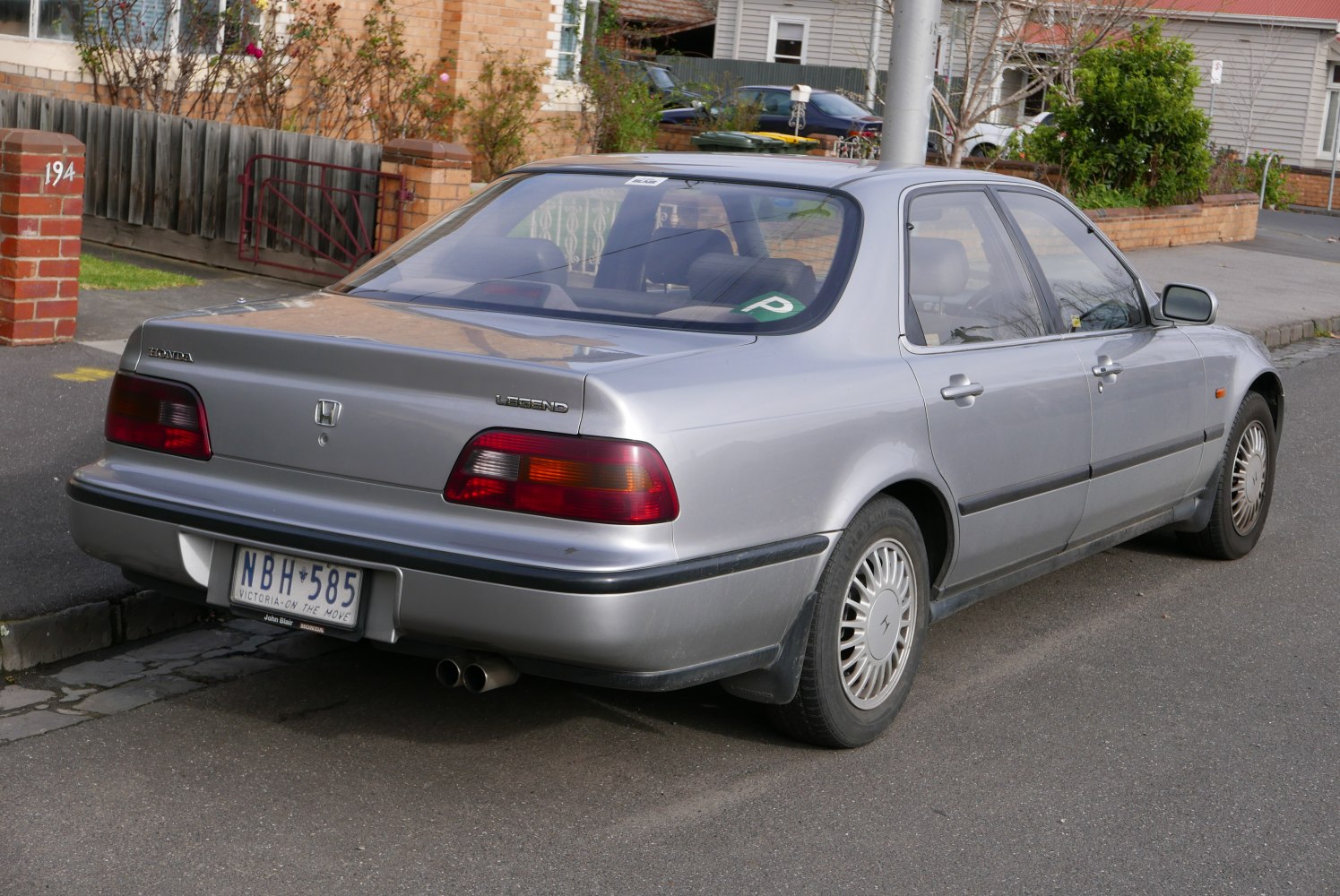 Silver sedan rear and side profile with taillights and alloy wheels
