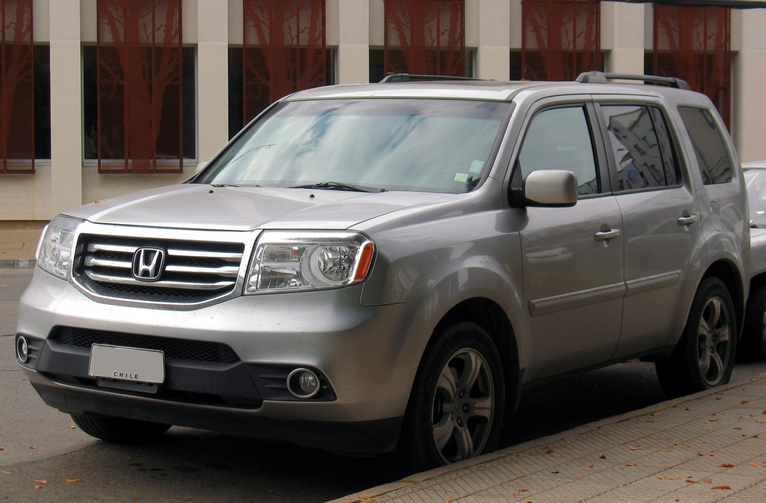 Silver midsize SUV with chrome grille and alloy wheels