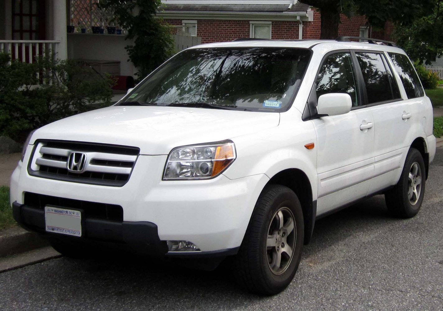 Front and side view of a mid-size SUV with updated grille and headlights