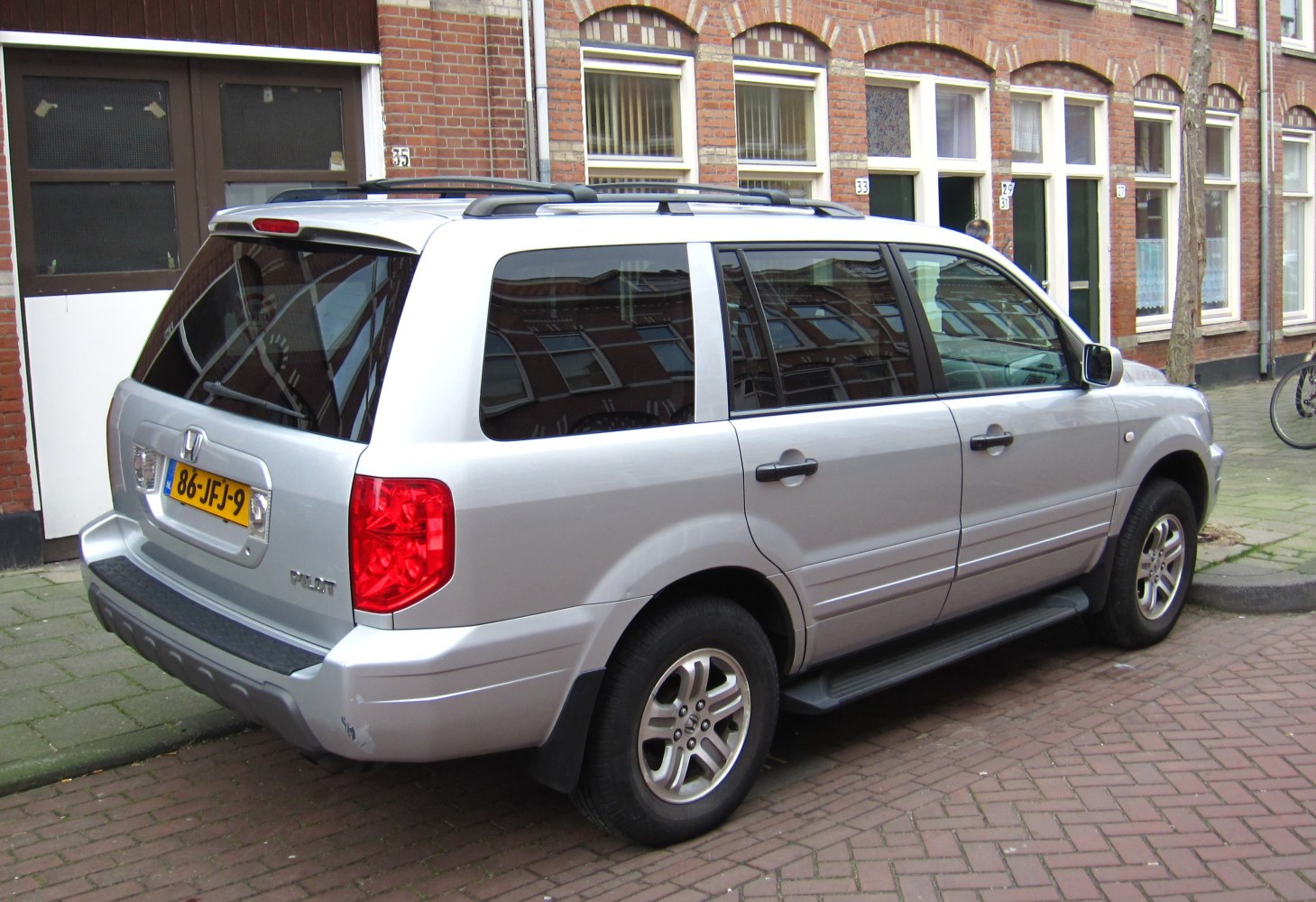Silver SUV rear-side view with roof rails and alloy wheels
