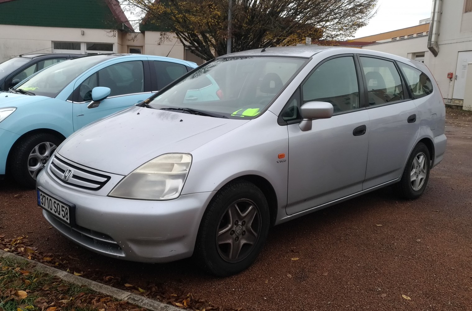 Silver compact MPV with front-side view, headlights, and alloy wheels