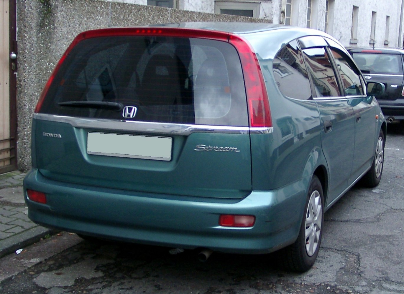 Rear view with vertical tail lights and tinted rear window.