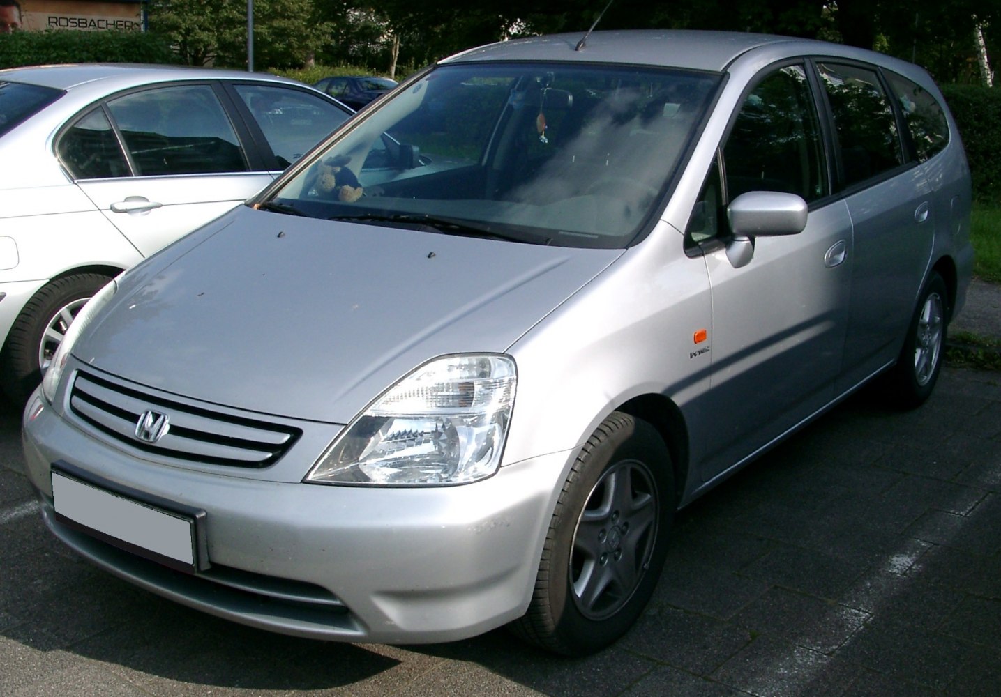 Silver compact MPV showing front and side view with clear headlights