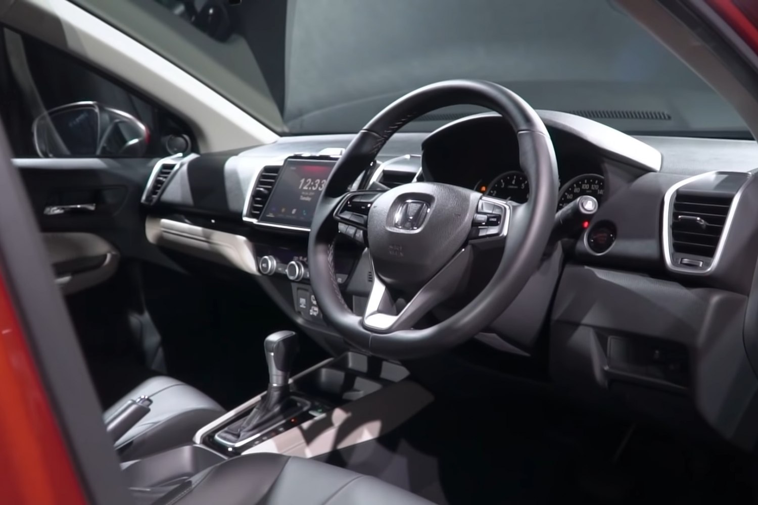 Modern dashboard and steering wheel with touchscreen infotainment and automatic gear lever