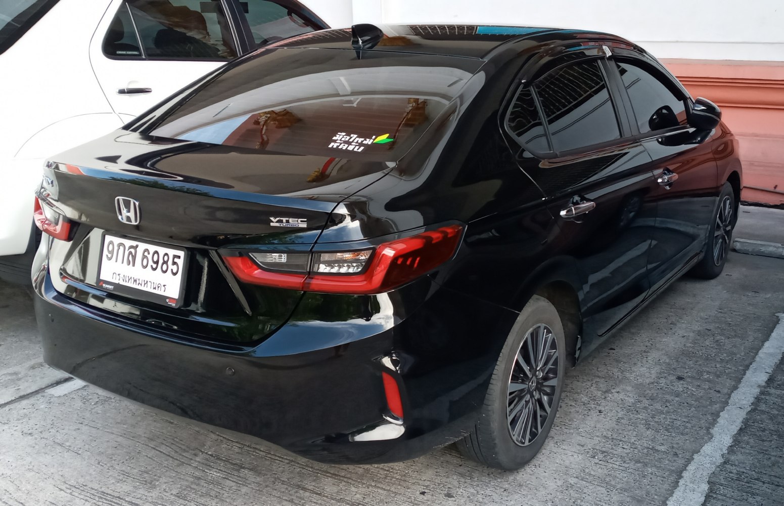 Rear angled black sedan with VTEC Turbo badge and modern tail lights.