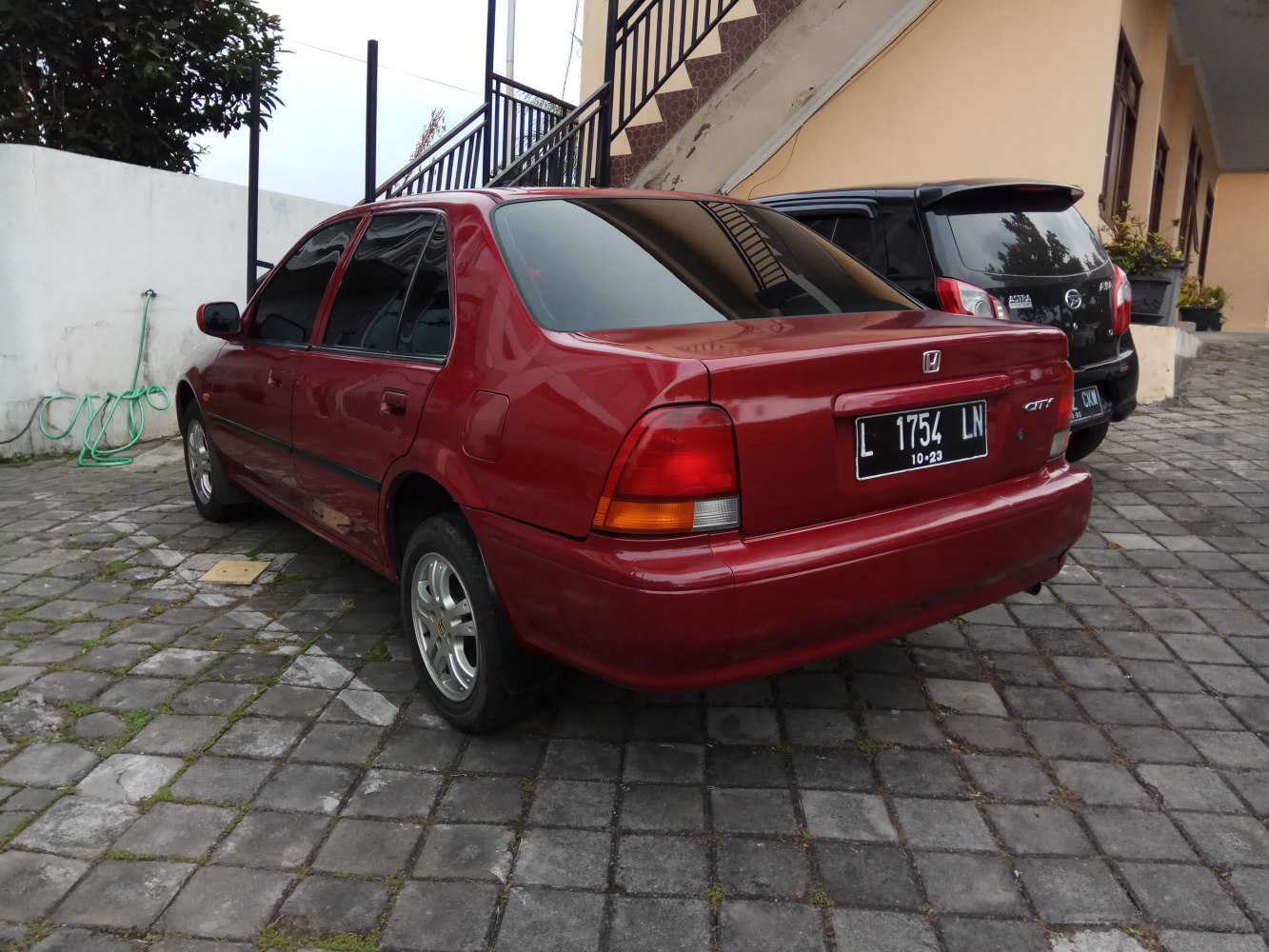 Classic sedan rear view with distinctive taillights and alloy wheels