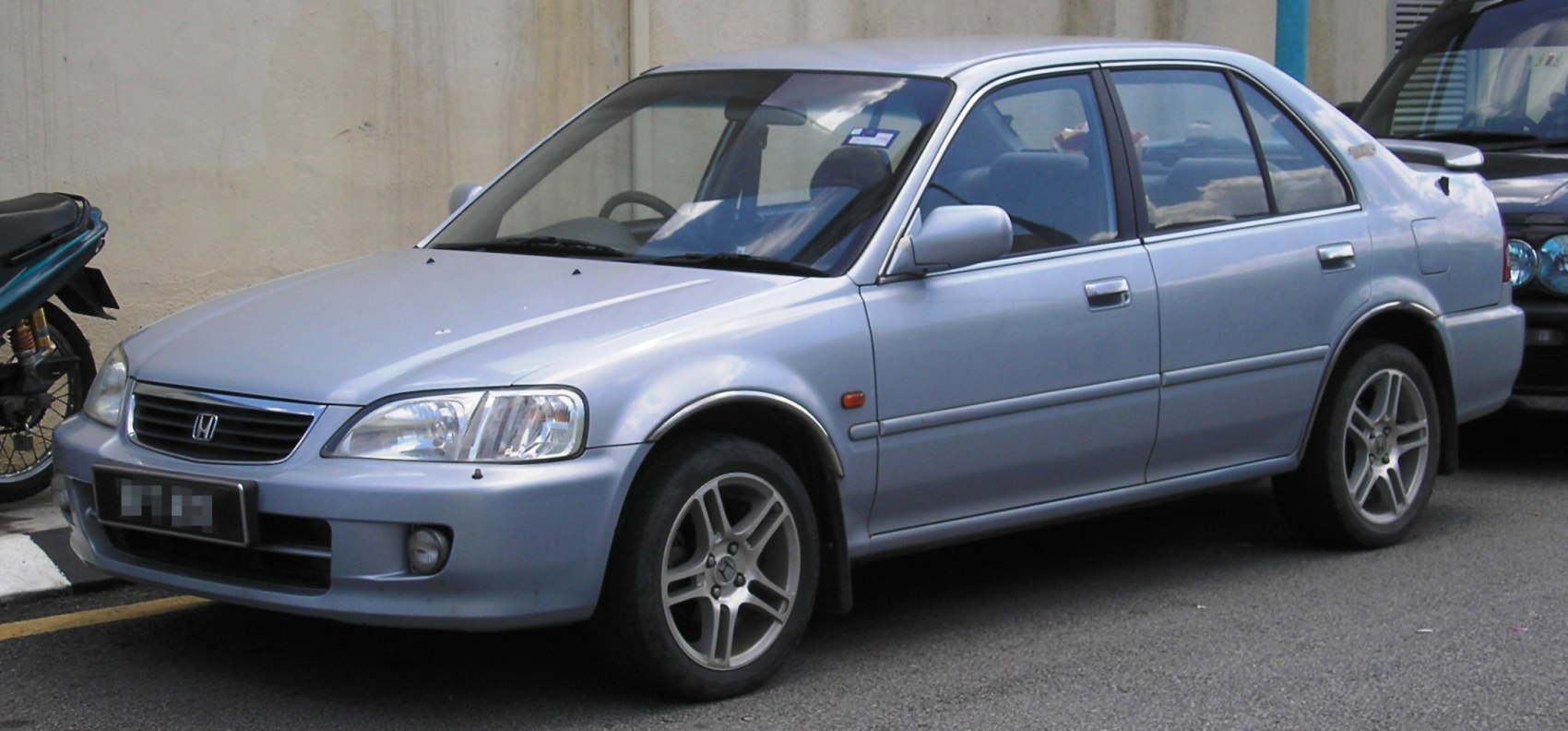 Side view of a sedan with alloy wheels and aerodynamic design.
